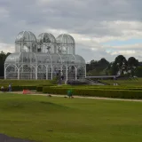 Stunning glasshouse at Curitiba's botanical garden under cloudy skies, Paraná, Brazil.