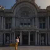 Ballet dancer posing gracefully at Palacio de Bellas Artes in Mexico City.