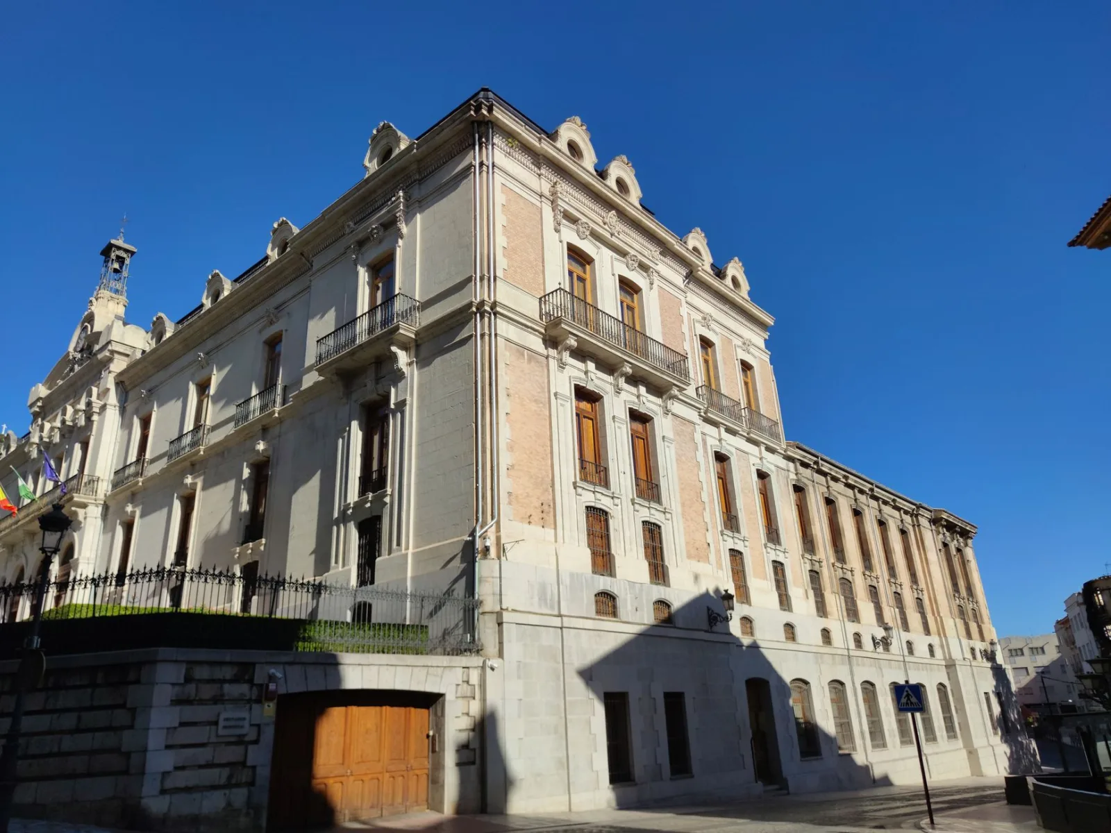 Elegant palace facade in Jaén, Spain, showcasing classic architectural style under a clear blue sky.