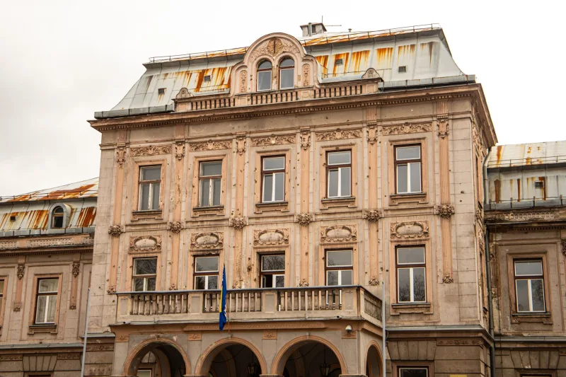 Explore the historic charm of classic Balkan architecture in Bosnia with this vintage building facade.