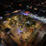 A vibrant aerial view of an illuminated plaza in Monte Cristi during the night.