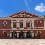 Front view of the historic Teatro Guerra in Lorca, Spain under a clear blue sky.
