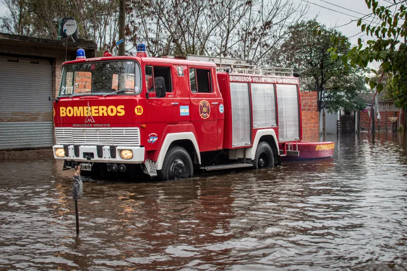 A fire truck drives through a flooded street in Buenos Aires, Argentina, during a storm.