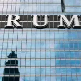Close-up of Trump Tower's glass facade with the city skyline reflection in the windows.