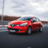 Dynamic shot of a red Renault Clio driving on a highway in Ankara, Türkiye.