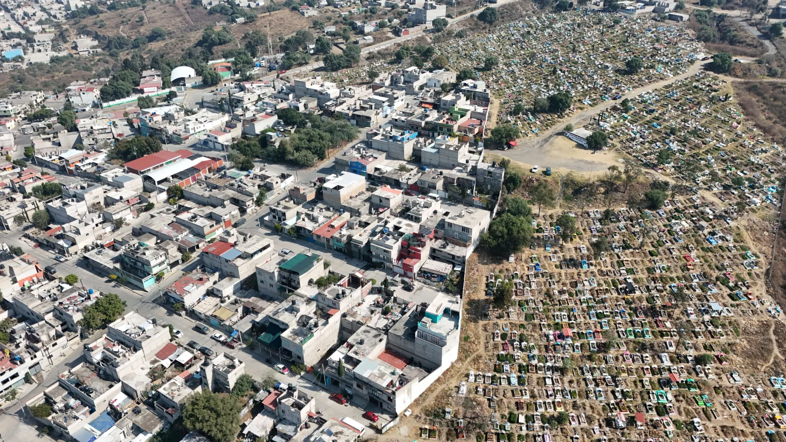 Drone shot showcasing the urban landscape and cemetery in Estado de México, México.