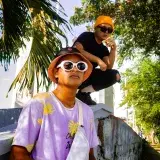 Stylish young men posing under palm trees in Túxpam de Rodríguez Cano, Veracruz, Mexico.
