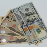 Close-up image of US dollars and Japanese yen notes, representing currency exchange concept.