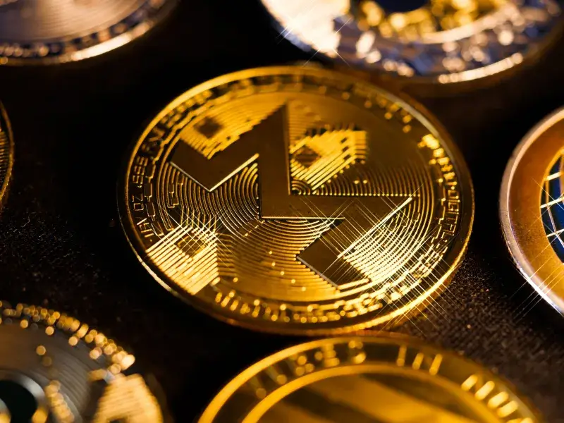 Shiny gold Monero coin close-up, focusing on digital currency aesthetics and investment potential.