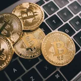 Close-up of multiple Bitcoin coins on a laptop keyboard symbolizing digital currency and cryptocurrency trading.