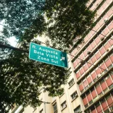 Street sign pointing to R. Augusta, Bela Vista, Zona Sul in São Paulo with urban backdrop.