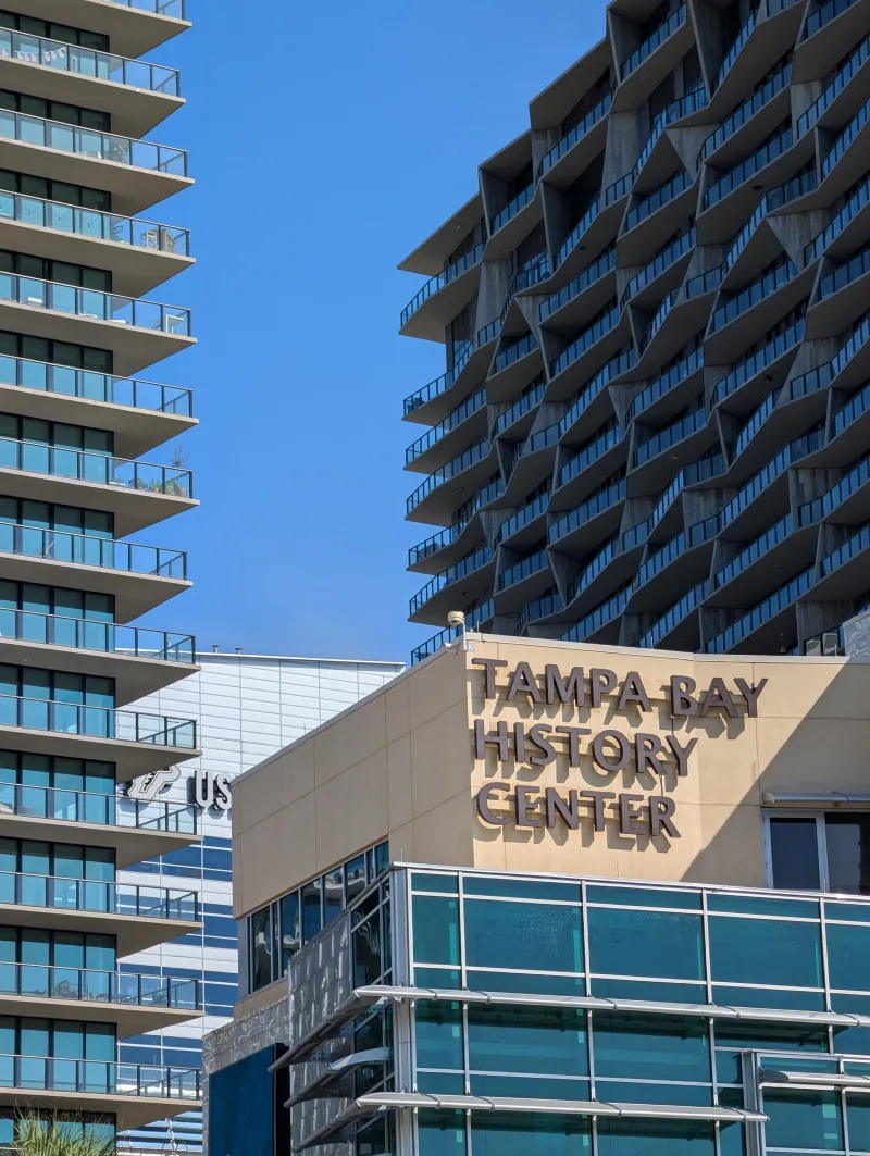 Tampa Bay History Center amid modern skyscrapers on a sunny day in Tampa, Florida.