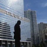 Captivating view of Chicago skyline with Trump Tower reflections and a silhouette in daylight.