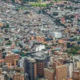 A vibrant aerial cityscape of Bogotá, Colombia, showcasing modern architecture and dense urban environment.