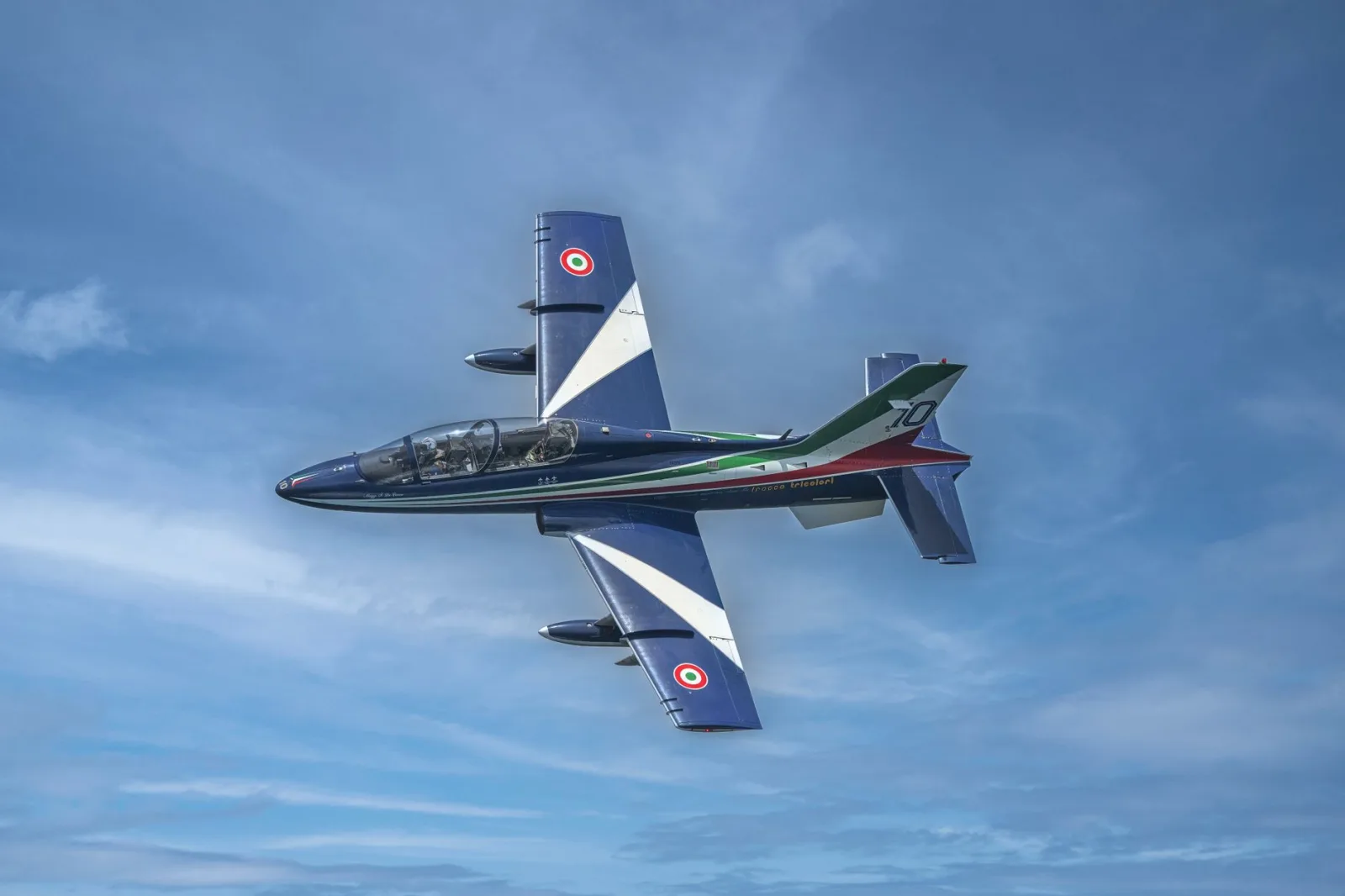 An aerobatic jet displaying impressive maneuvers in the clear blue sky over San Javier, Región de Murcia, España.