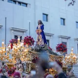 Vibrant Holy Week procession featuring an ornate religious float, in Madrid, Spain.