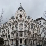 A view of the historic Edificio Grassy in Madrid showcasing its ornate architecture and urban setting.