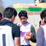 A youth football team strategizing during practice in Toluca de Lerdo, Mexico.