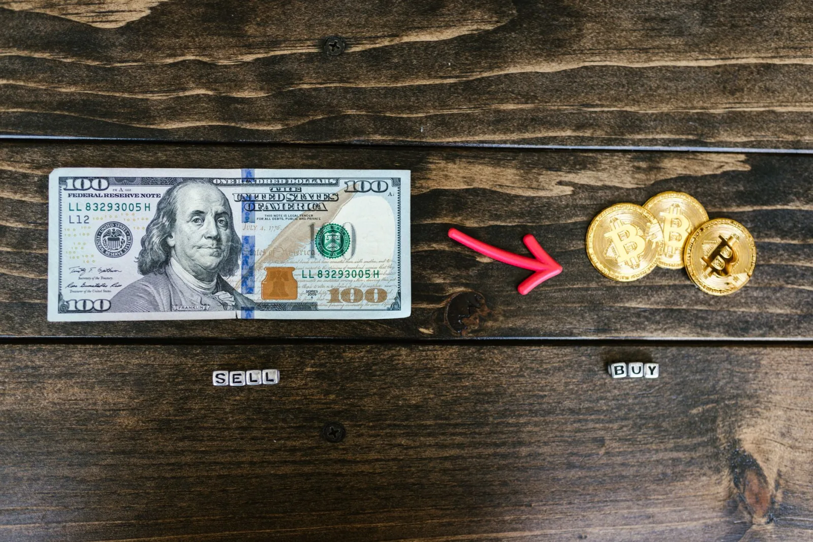 Las monedas de bitcoin y un billete de dólar simbolizan el intercambio de divisas digitales y tradicionales.