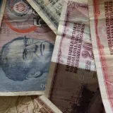 A close-up photo of diverse vintage banknotes, showcasing historical currency from different countries.