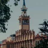 Stunning view of Sant Pau Hospital's modernist architecture in Barcelona with lush greenery.