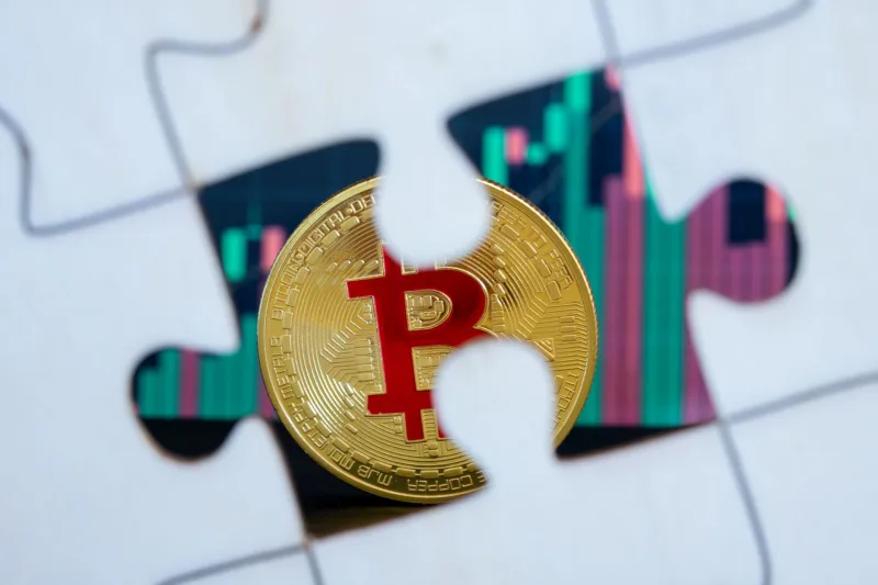 A Bitcoin coin placed in a puzzle piece against a financial chart backdrop, symbolizing digital currency investment.