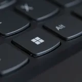 Detailed close-up of a computer keyboard featuring the Windows key in focus.