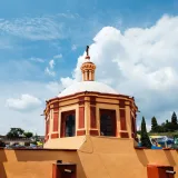 Vibrant dome of San Miguel del Milagro Church in Tlaxcala, Mexico under a clear blue sky.