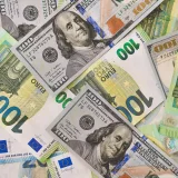 A detailed view of American and Euro currency notes, emphasizing global finance.