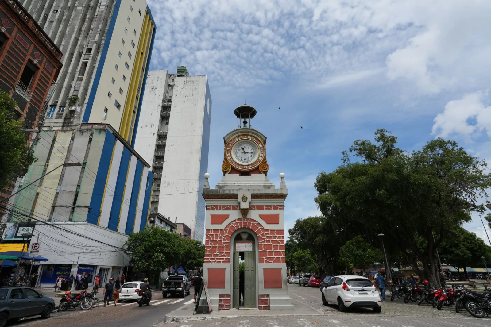 Historic clock tower Relógio Municipal amidst cityscape in Manaus, Brazil.